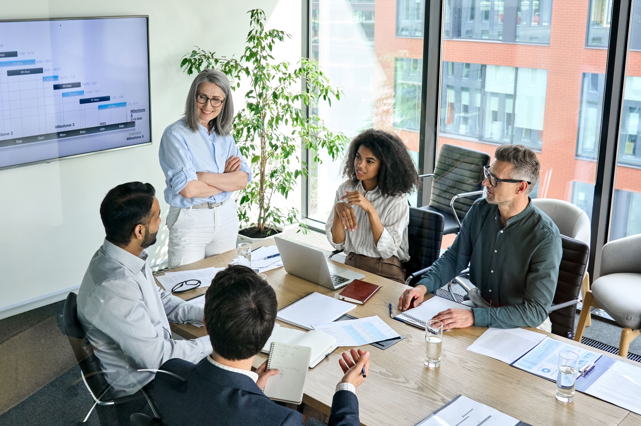 A woman presenting to her colleagues.