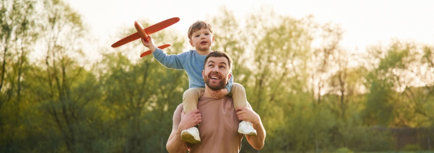 A father with a child sitting on his shoulders.