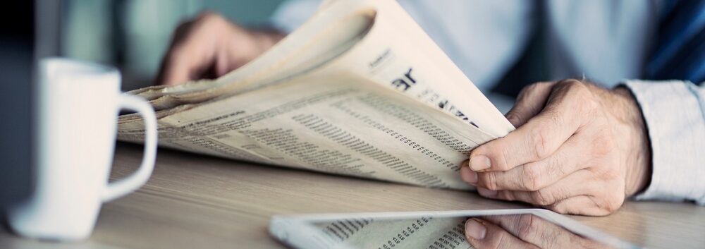 A man reading a newspaper.