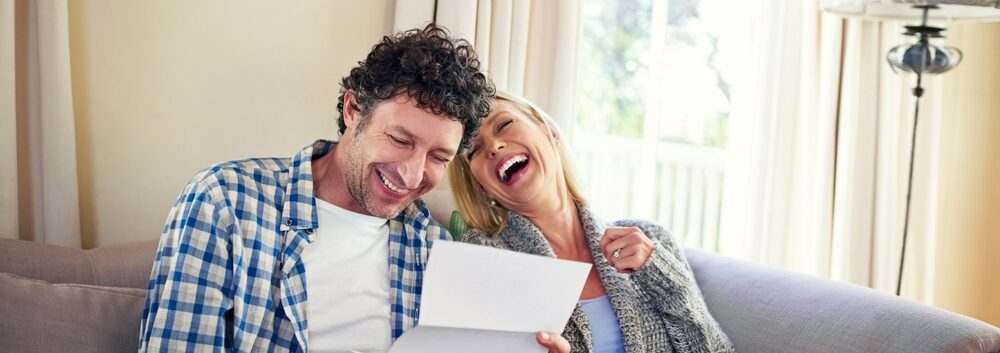 A happy couple reviewing paperwork.